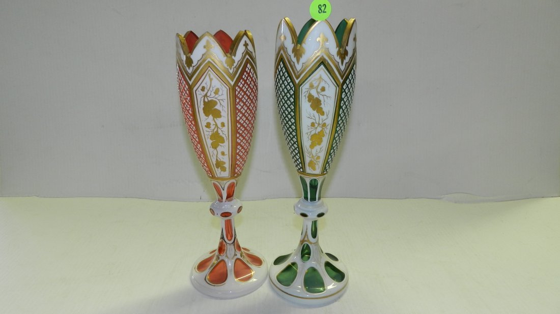 2 piece Antique Bohemian Cut Glass Mantle Luster vases: 2 piece Antique Bohemian Cut Glass Mantle Luster vases in both Green & cranberry with White & gold Floral design, 11 1/2 cond G-VG cranberry tip has small chip,