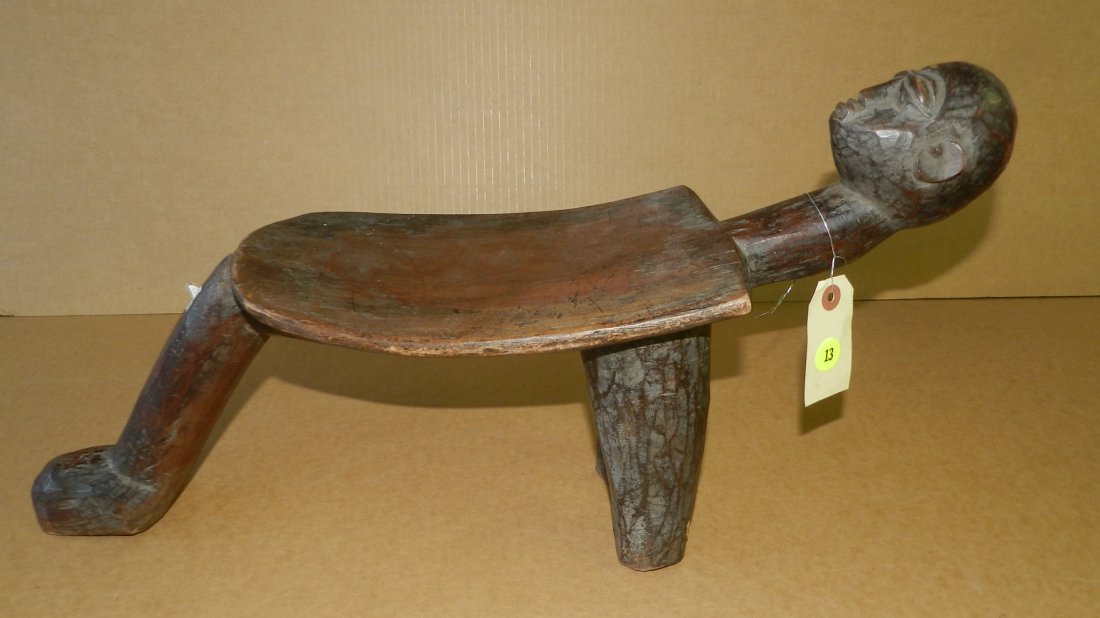 1401) nice African carved Lobi 3 legged stool with: 1401) nice African carved Lobi 3 legged stool with man's head design, from the Burkina Faso in West Africa, estate paid $850. cond VG 11 x 21 x 6 1/2
