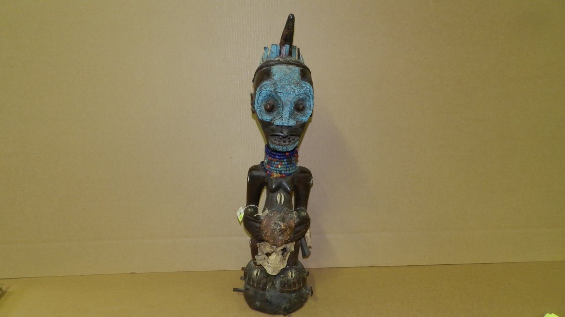 630) African carved Power figure w/ horn, metal shims,: 630) African carved Power figure w/ horn, metal shims, fur, cowries, spikes and metal on face, from DR Congo, COND G, 29 1/4"