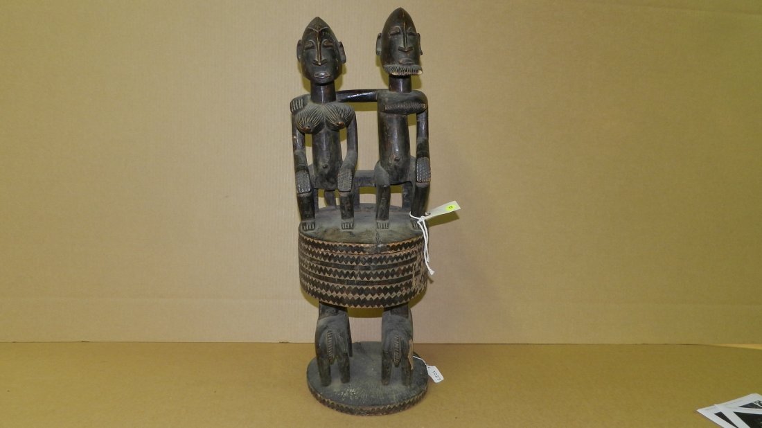 1027) African carved Dogon Bowl with cover and couple: 1027) African carved Dogon Bowl with cover and couple atop, man with arm around wife, seated on fitted lid atop 2 animals, cond G, minor loss, 30x10