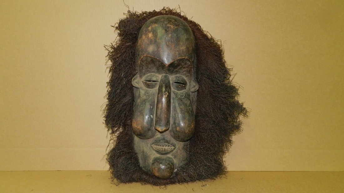 677A) massive African carved Large Yaka mask. Blackened: 677A) massive African carved Large Yaka mask. Blackened wood with attached raffia. In good condition, appropriate for age, origin, and mediums. Areas rubbed, some loss on nose. 37" x 27 (with raffia)
