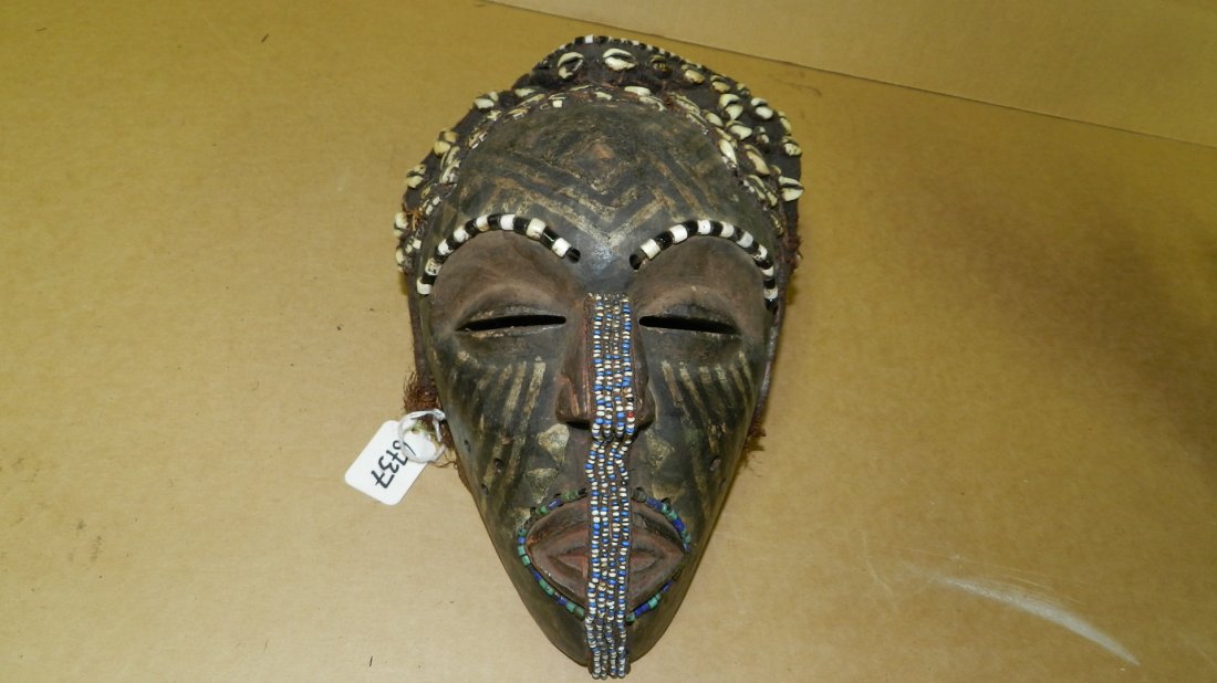 6737) unique African carved mask with striped paint: 6737) unique African carved mask with striped paint design, made with trade beads and shell, 10x7