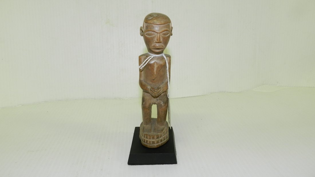 9133) small African carved Standing asexual figure on p: 9133) small African carved Standing asexual figure on pedestal, light wood. 7 1/4