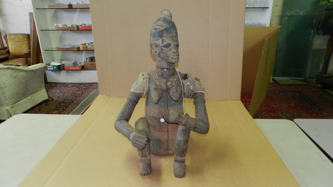 167) Large African carved seated puppet with crossed ar: 167) Large African carved seated puppet with crossed arms; cloth. From Nigeria. 26 1/2 x 16 x 15