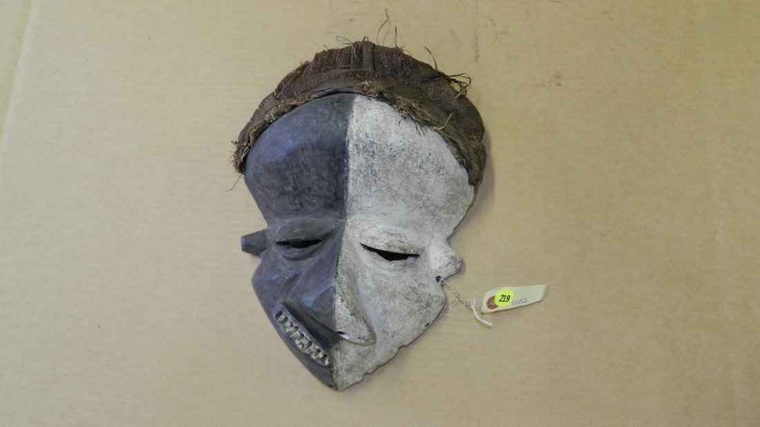1882) African Pende mask with deformation. Half black,: 1882) African Pende mask with deformation. Half black, half white with fiber head covering. COND G, appropriate for age, origin &n mediums. From DR Congo. 14 x 9 x 6