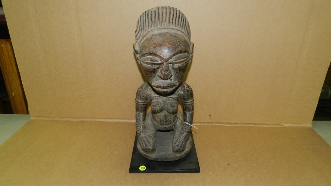1803) African carved Luba kneeling female figure, on st: 1803) African carved Luba kneeling female figure, on stand, from DR Congo. 18"