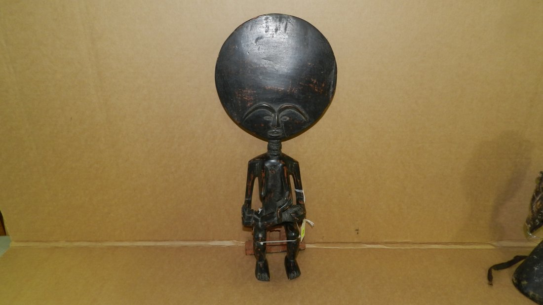 6928) African carved sitting maternity figure, repair t: 6928) African carved sitting maternity figure, repair to left leg. From Ghana. 19"