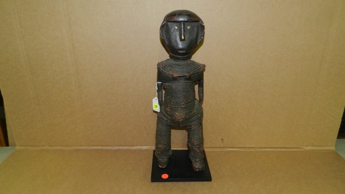 5099) African carved figure, Tanzanian statue, wrapped: 5099) African carved figure, Tanzanian statue, wrapped with rope, blackened. 18 1/2"