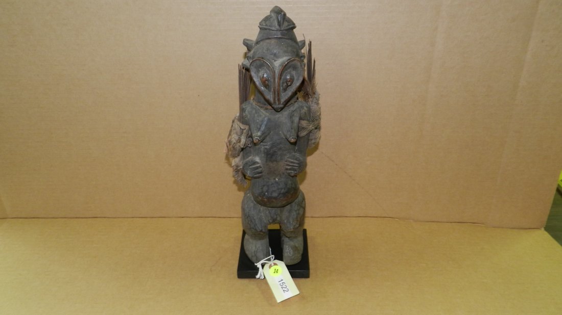 1522) African carved Yaka female fetish figure with arm: 1522) African carved Yaka female fetish figure with arm bundles. From DR Congo. 15 1/2"
