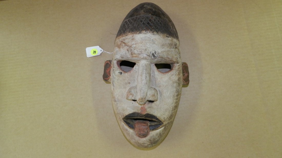 4022) West African carved white faced mask with: 4022) West African carved white faced mask with extended red tongue. 13 x 8 1/2 x 4
