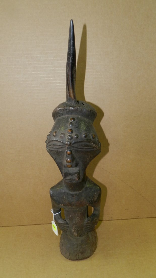 9360) African carved Songye half-figure with horn atop: 9360) African carved Songye half-figure with horn atop and tacks on face. From DR Congo. 24"