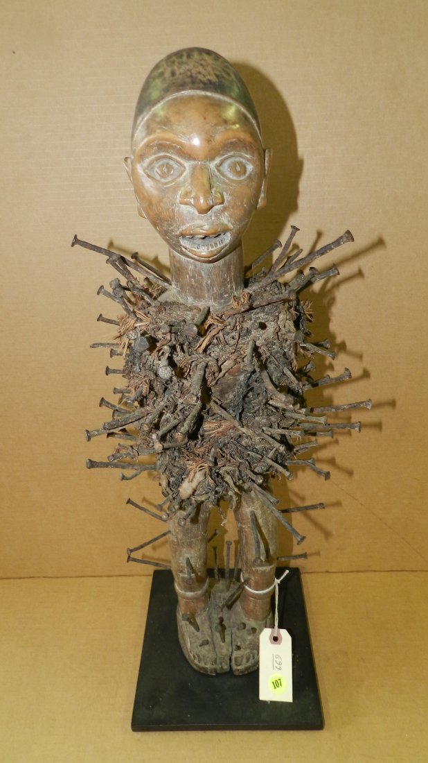 699) African carved power figure with nails, on stand.: 699) African carved power figure with nails, on stand. From DR Congo. 24 1/2"