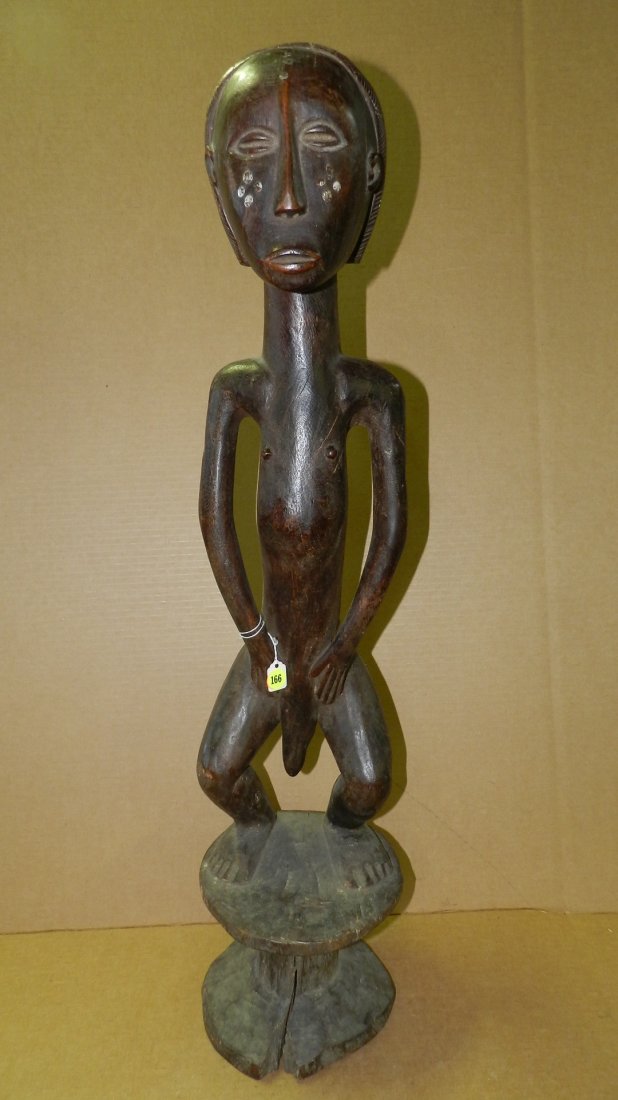 896) unique African hand carved Tall figure on stool.: 896) unique African hand carved Tall figure on stool. White metal inlay on face. 33" from the Nyamwezi Tanzania