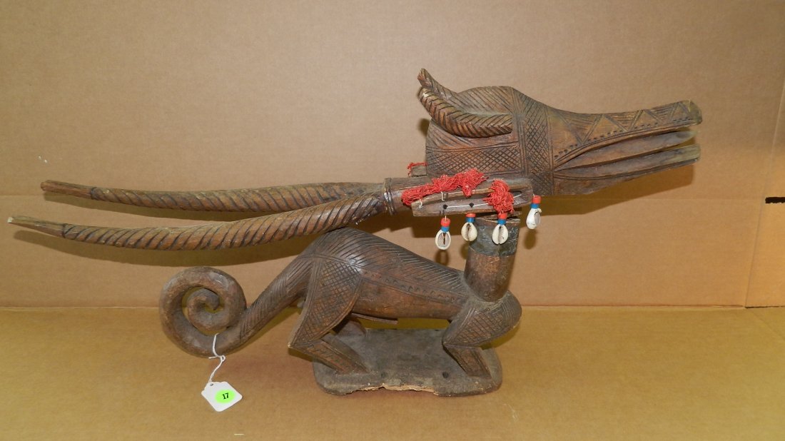 7028) West African carved animal figure, broken at: 7028) West African carved animal figure, broken at neck, repairable. 12 x 25