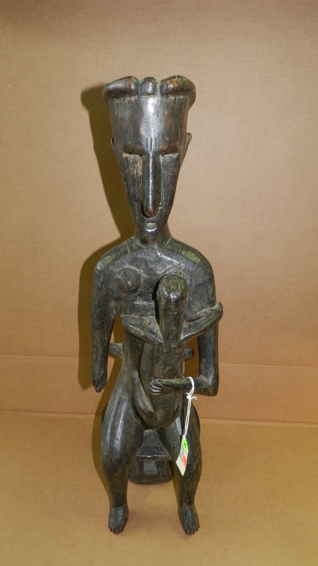5718) African carved Bamana maternity figure sitting on: 5718) African carved Bamana maternity figure sitting on stool with 2 children. 27 1/2"