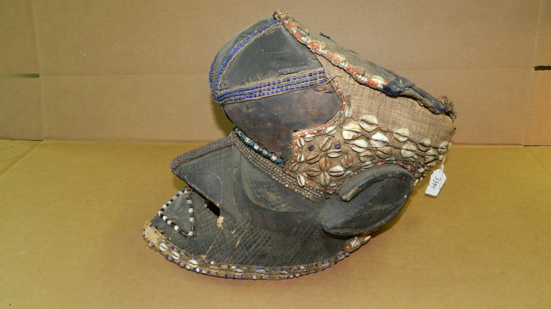 3394) African BEADED HELMET MASK. KUBA TRIBE. Blackened: 3394) African BEADED HELMET MASK. KUBA TRIBE. Blackened wood with attached metal sheet, burlap, cowr