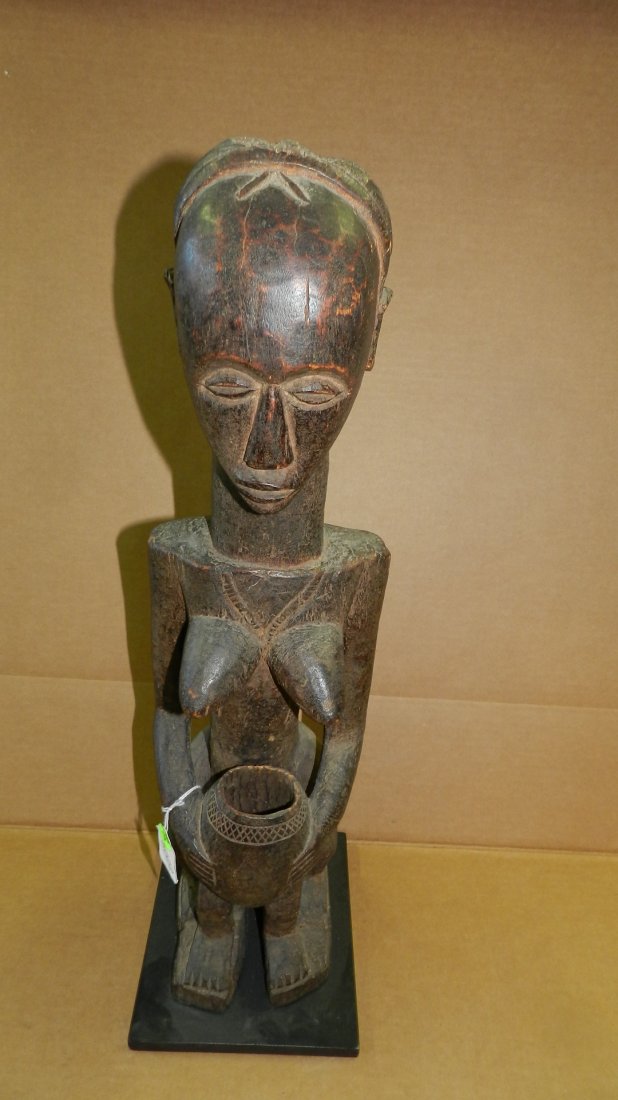 5022) African carved Standing female figure holding: 5022) African carved Standing female figure holding bowl with human legs Zaramo Tanzania 23" tall