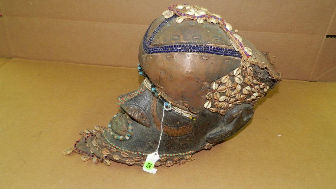 3394) HELMET MASK. KUBA TRIBE. Blackened wood with: 3394) HELMET MASK. KUBA TRIBE. Blackened wood with attached metal sheet, burlap, cowries, and polychrome beads. FROM DR CONGO. 13 1/2