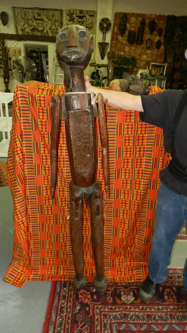 57) A PAIR OF EAST AFRICAN STANDING FIGURES, MALE AND: 57) A PAIR OF EAST AFRICAN STANDING FIGURES, MALE AND FEMALE. Carved wood stained reddish brown with attached metal on facial features and abdomen. Each with separately carved and attached legs and ar