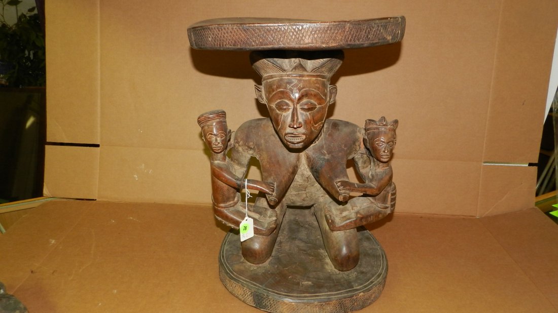 13192) African carved Chokwe stool, kneeling female: 13192) African carved Chokwe stool, kneeling female with two infants. Wood with brown stain. From DR Congo. Some cracks on seat and base. 19 x 13