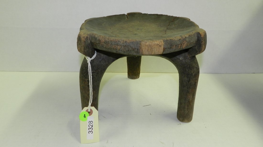 3328) African carved simple Nyamwezi stool, piece missi: 3328) African carved simple Nyamwezi stool, piece missing from one leg. From Tanzania. 8 x 10