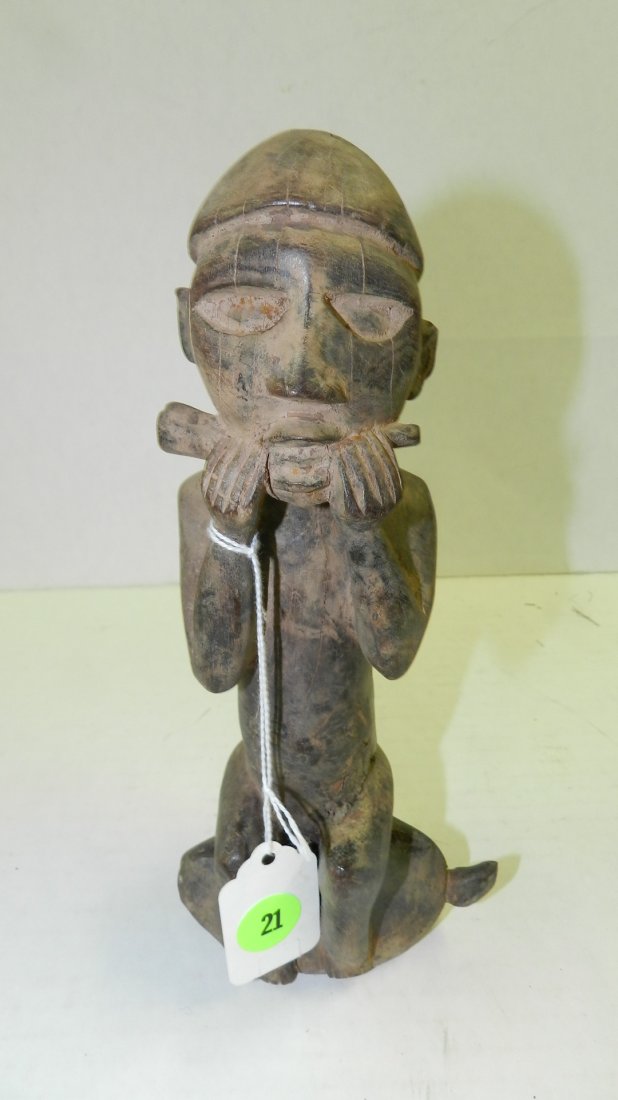 5423) African carved sitting asexual figure on animal p: 5423) African carved sitting asexual figure on animal playing instrument. From DR Congo. Shows splits/crack. 9"