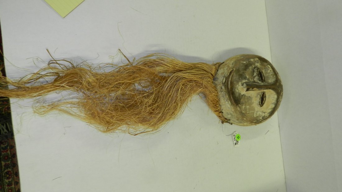 6765) African carved Lega mask w/remains of white pigme: 6765) African carved Lega mask w/remains of white pigments & perforations around the perimeter for attachments. From DR Congo.9 x 8 x 3 w/ Raffia 29"