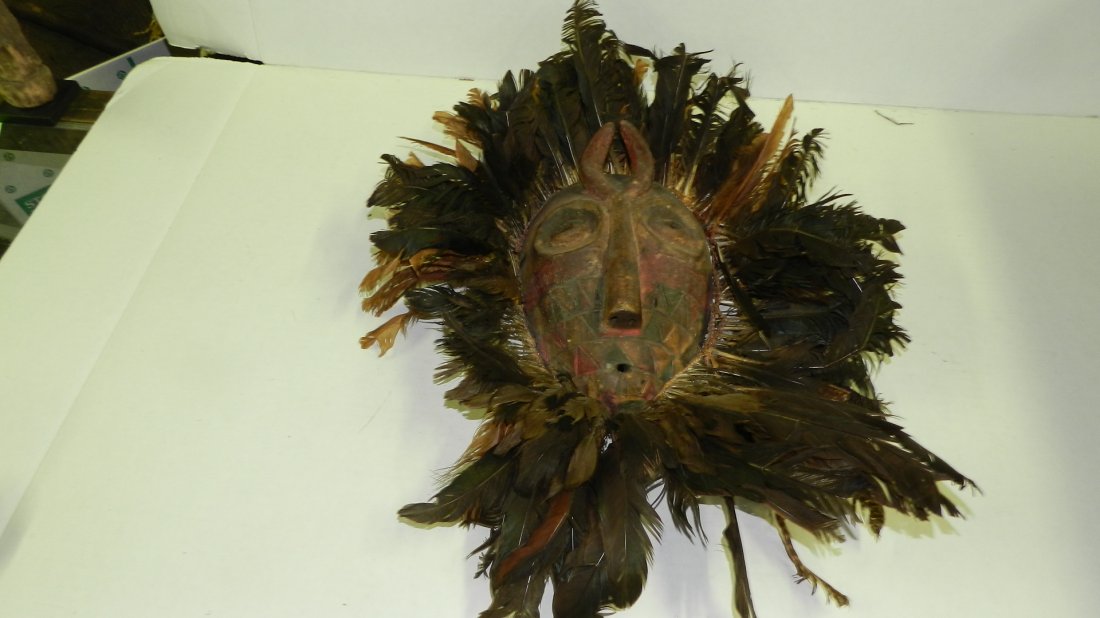 1754) African carved Nafana Bedu mask with feather surr: 1754) African carved Nafana Bedu mask with feather surround, some loss to feathers. From Ivory Coast. 22 x 17