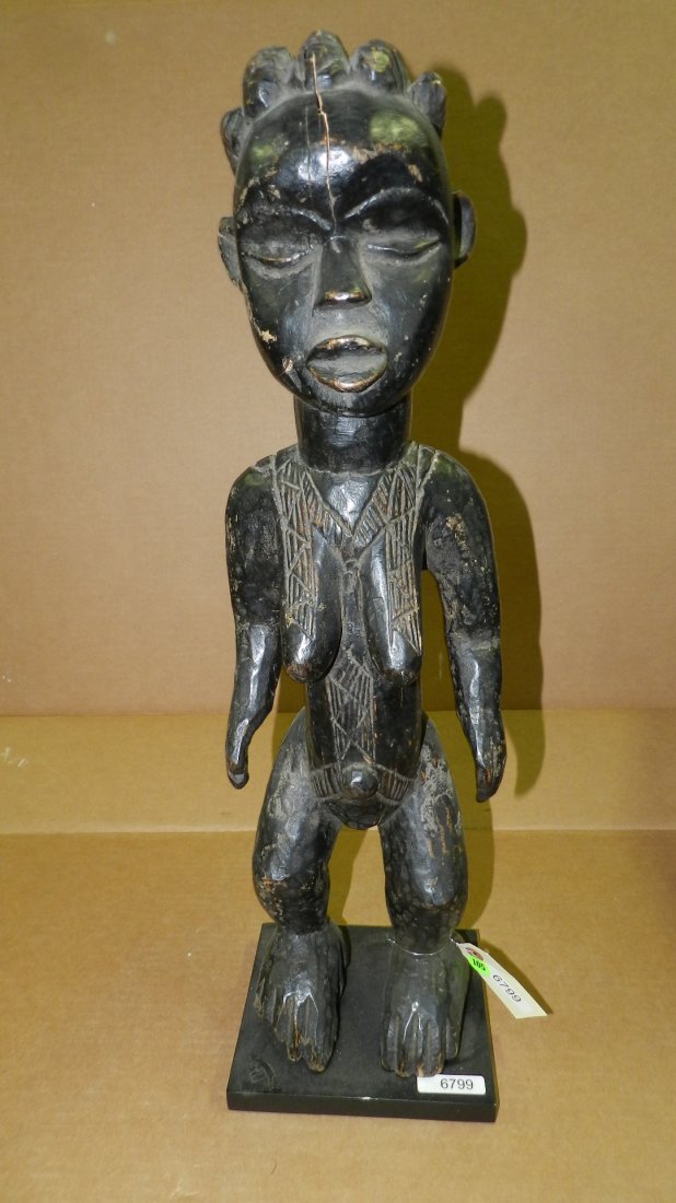 6799) African carved standing figure, on stand, from Iv: 6799) African carved standing figure, on stand, from Ivory Coast. 25"
