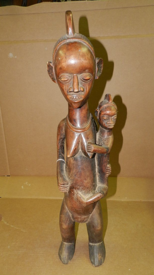 5865) African carved Yaka maternity standing figure, on: 5865) African carved Yaka maternity standing figure, on stand. From DR Congo. 30"