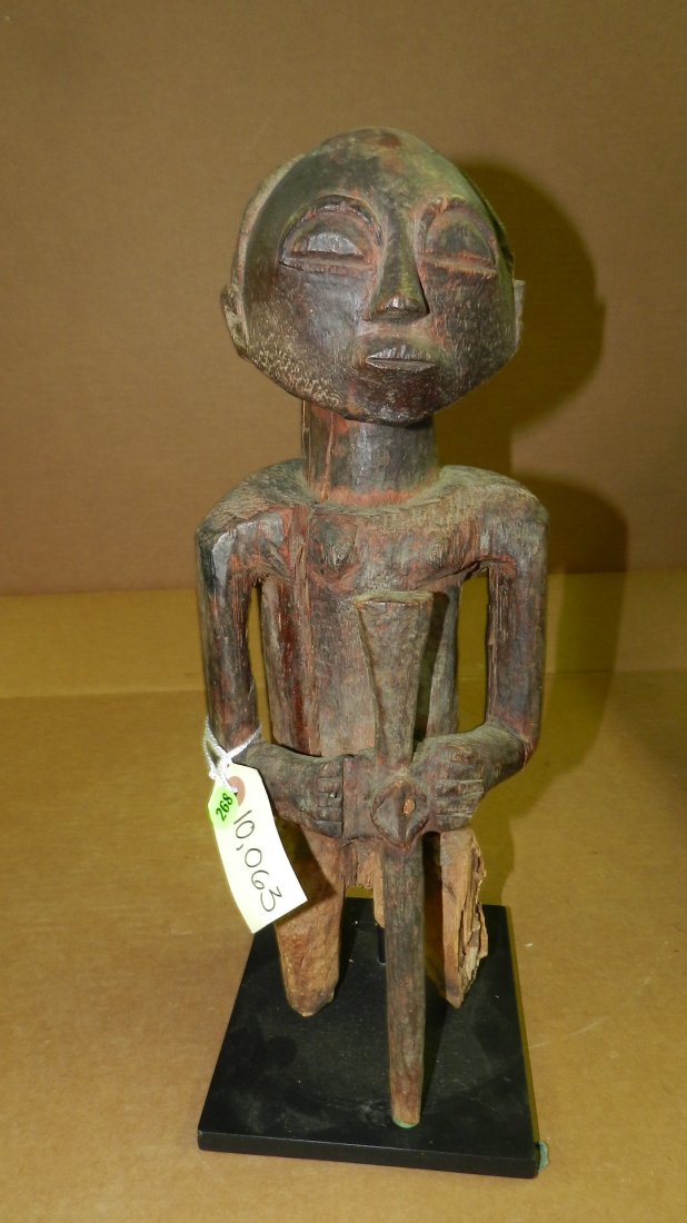 10063) African carved standing male Luba figure with er: 10063) African carved standing male Luba figure with eroded legs and several cracks. From DR Congo. 18"