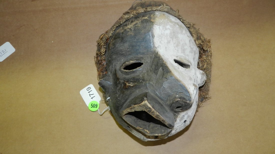 1719)Pende (DR Congo) mask w/ deformations. Wood with f: Pende (DR Congo) mask w/ deformations. Wood with face divided in black and white. High points rubbed. - 10"