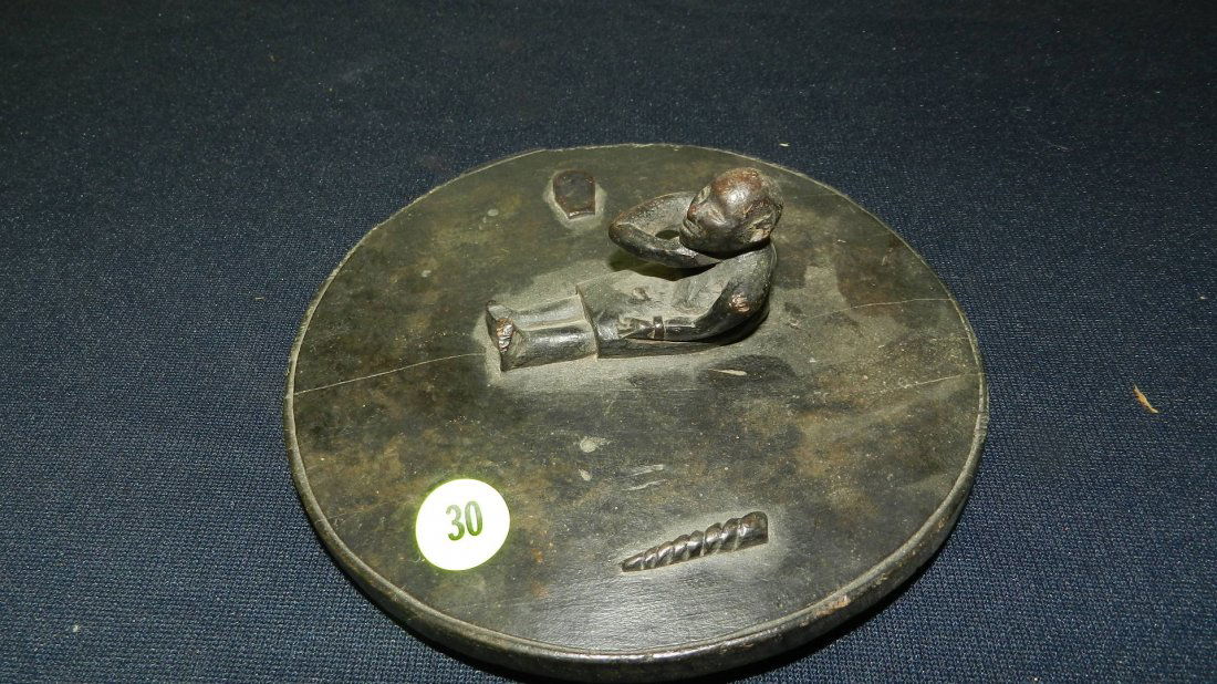 Unique African hand carved figure on disk, man holding (1 of 5)