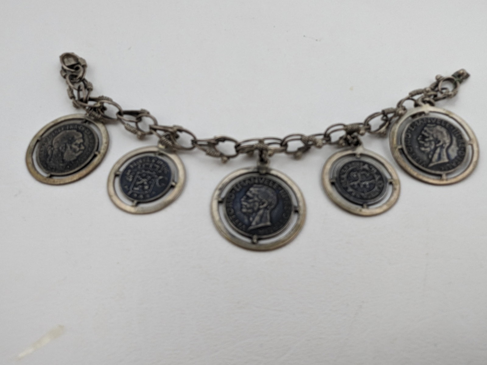 Coin and Silver Charm Bracelet marked 800: Coin and Silver Charm Bracelet marked 800 length 6 inches