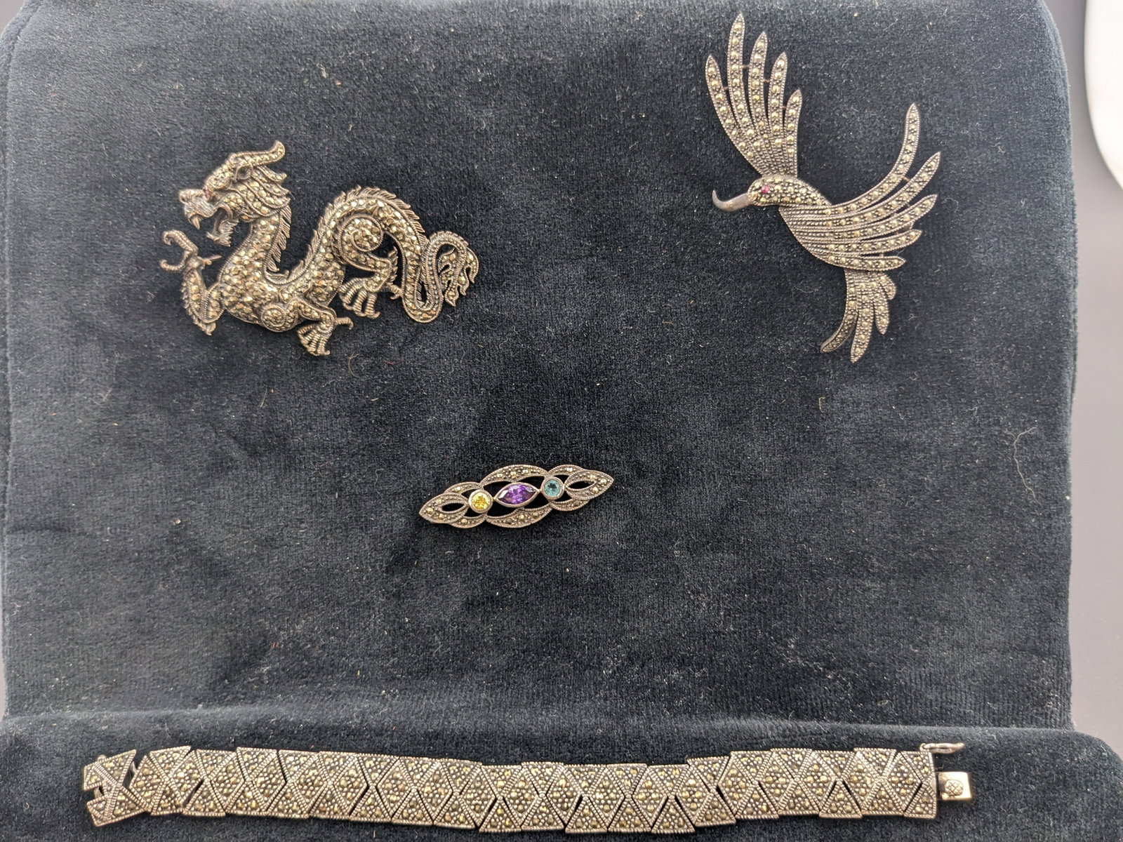 Marquisite Jewelry: Marquisite jewelry. One 7 inch braceletTwo pins one dragon and one craneOne bar pin with stones.
