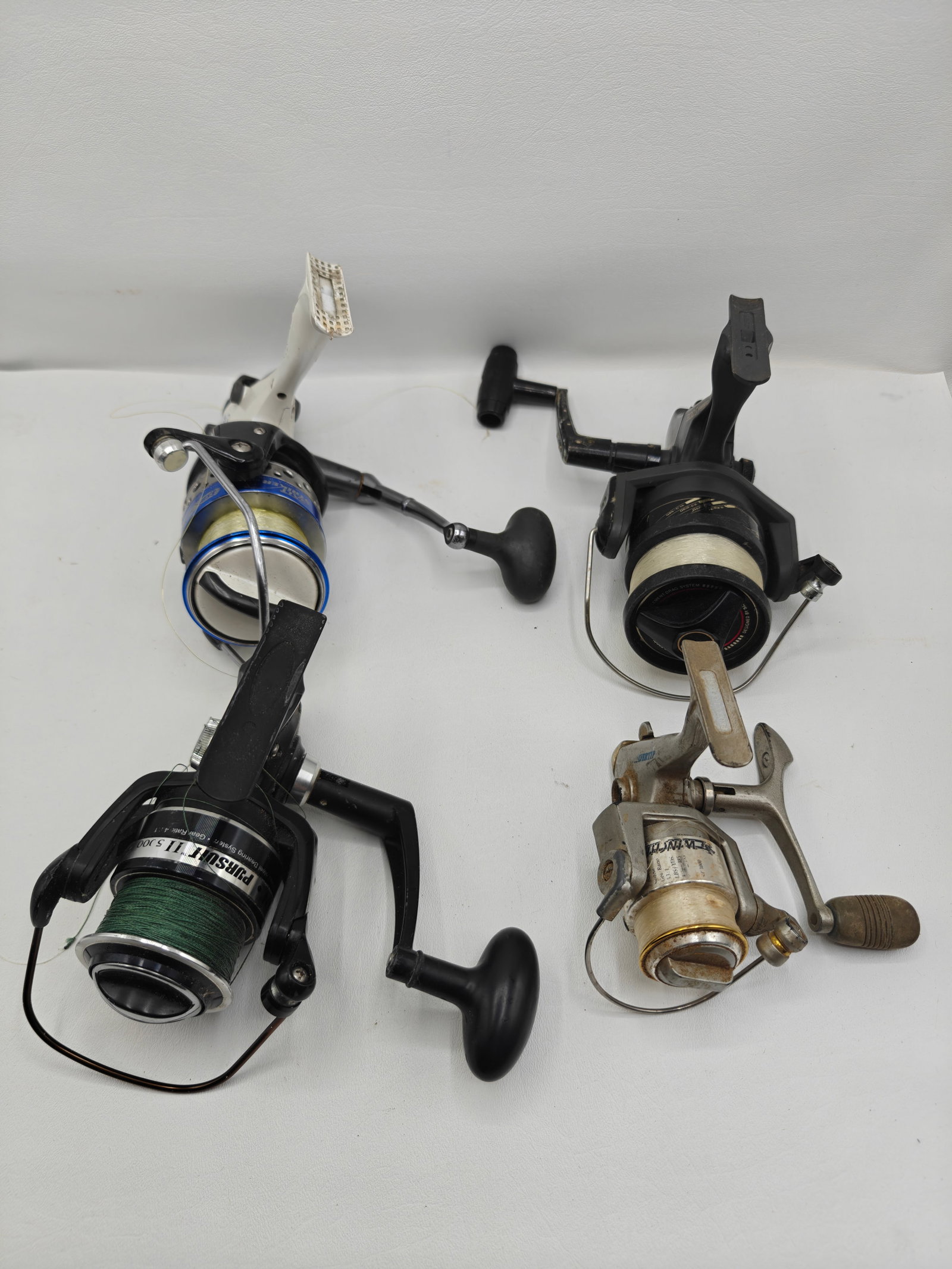 Four Spinning Fishing Reels: Lot of four spinning fishing reels. Shimano 500S, Penn Pursuit II 5000, Winchester Silvertip ST3000, Cabela Salt Striker SSBF 65B. Condition as shown