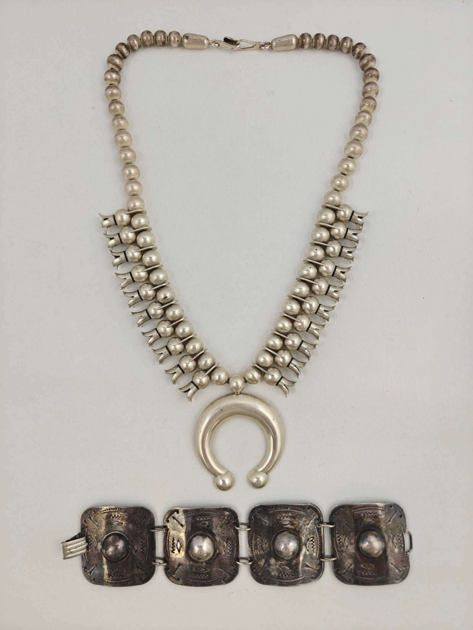 Sterling Squash Blossom Necklace (199g) and Bracelet (60g): Sterling Squash Blossom Necklace (199g) and Bracelet (60g). Necklace is 26" in length, 199g, and marked JB. Bracelet is 7" and 60 g.