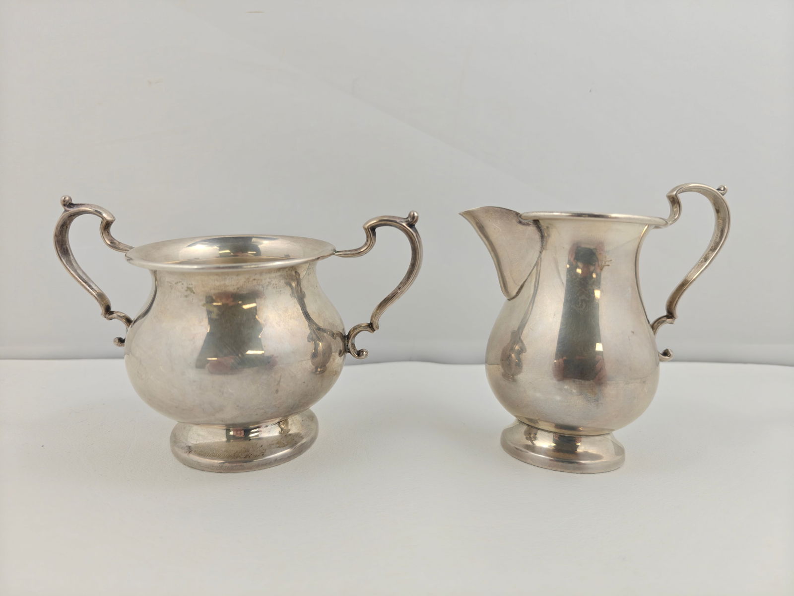 Hunt Silver Co. Sterling Silver Cream & Sugar, 197g: Hunt Silver Co. sterling creamer and sugar, pattern 151. Each piece marked with Hunt hallmarks including script oval, shielded H, lion passant, and stamped STERLING 151. Classic baluster form with scr