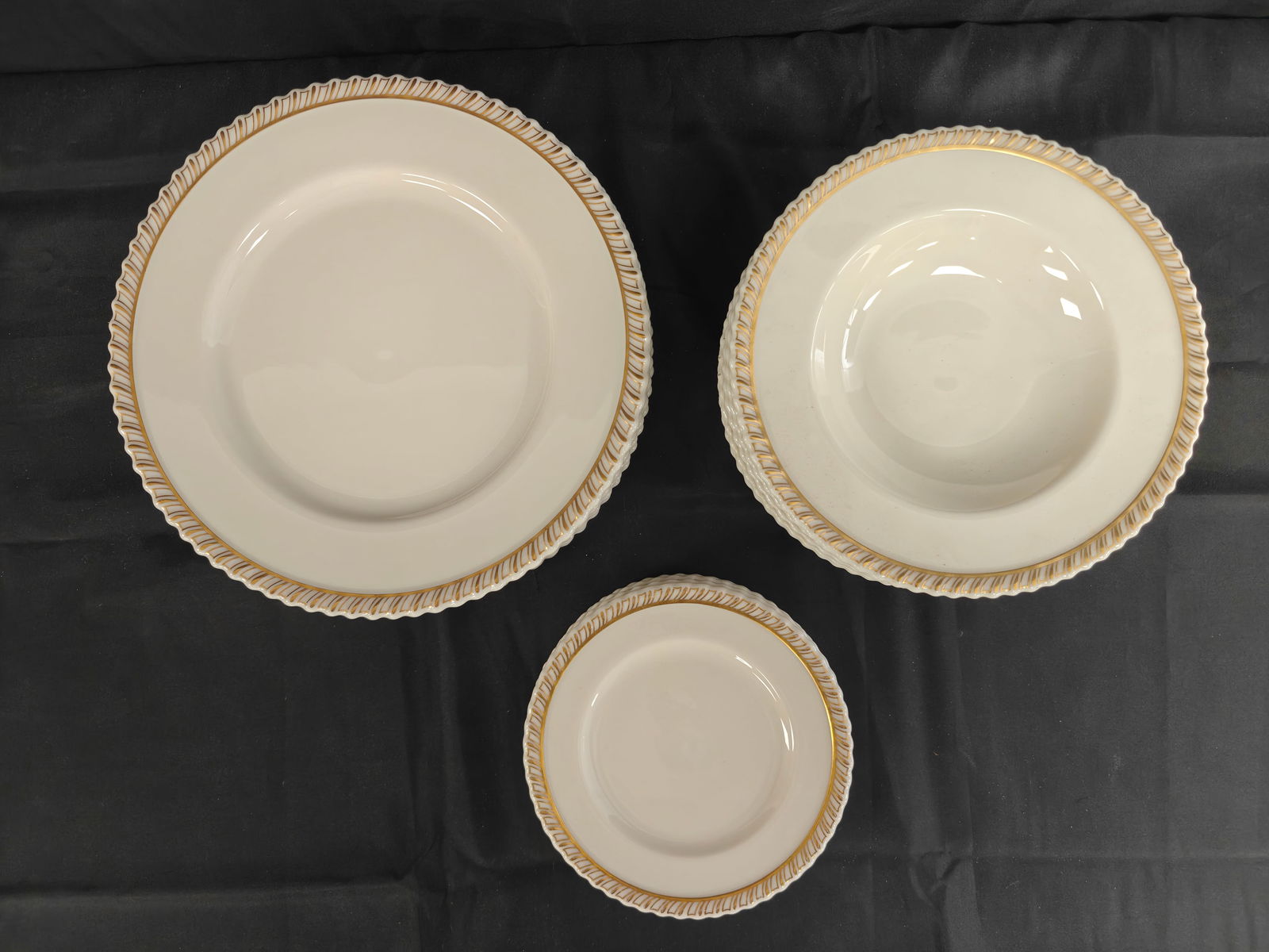 Lenox for Tiffany & Co. Gilt Rim Dinnerware Service, 23 Pieces, Pattern H310: A fine porcelain dinnerware service made by Lenox, retailed by Tiffany & Co., New York. The set includes 7 10.5" dinner plates, 8 8.25" salad plates, and 8 6.25" dessert plates, each decorated with a