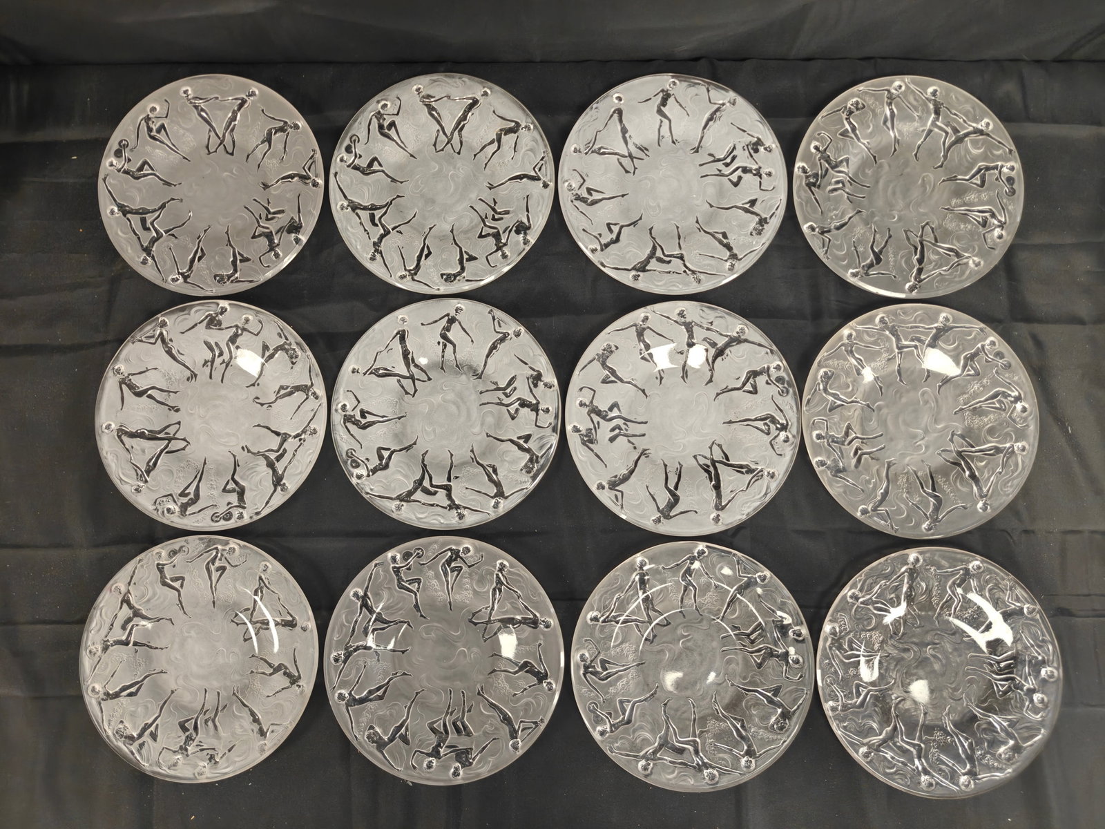 Set of 12 Consolidated Glass Art Deco ?Dancing Nymph? Plates: A set of twelve pressed glass plates by Consolidated Glass, circa 1920s–30s, in the celebrated Art Deco “Dancing Nymph” pattern. Each plate measures 8.25 inches in diameter, molded with fros