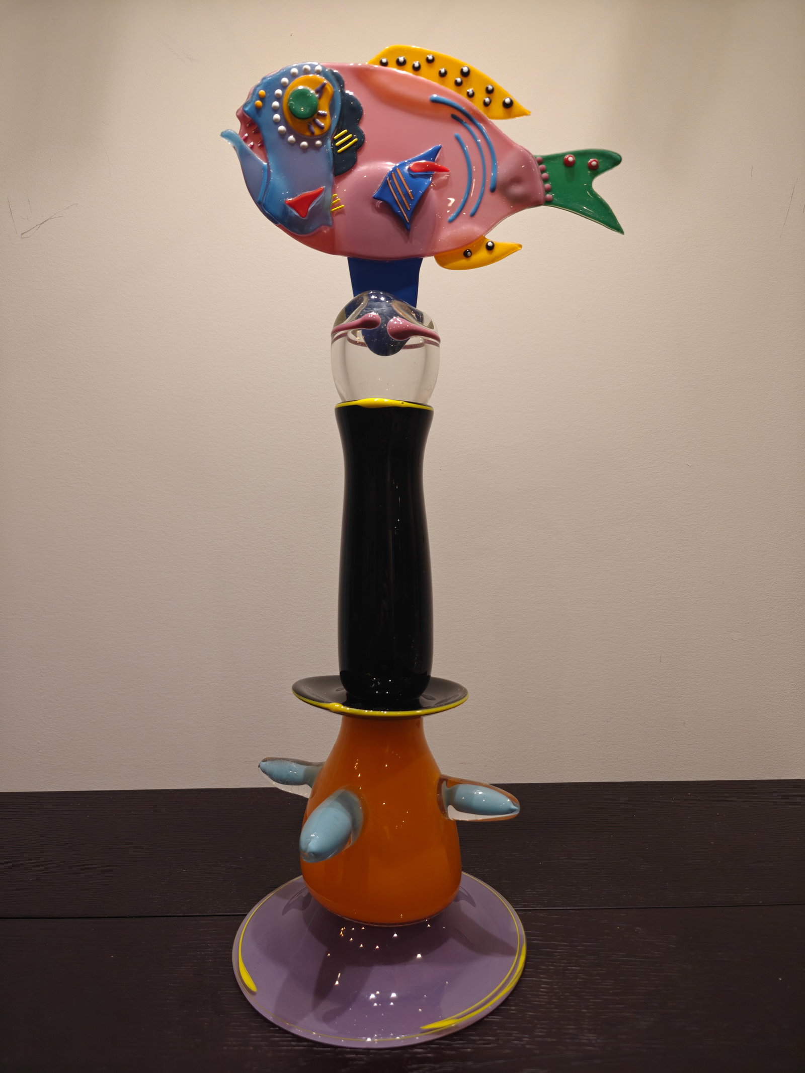 James Van Deurzen Two-Piece Whimsical Glass Sculpture: Playful handblown and fused glass sculpture by James Van Deurzen, signed and numbered #2020. The two-part work features a vibrant pedestal base in orange, black, lilac, and turquoise glass, supporting