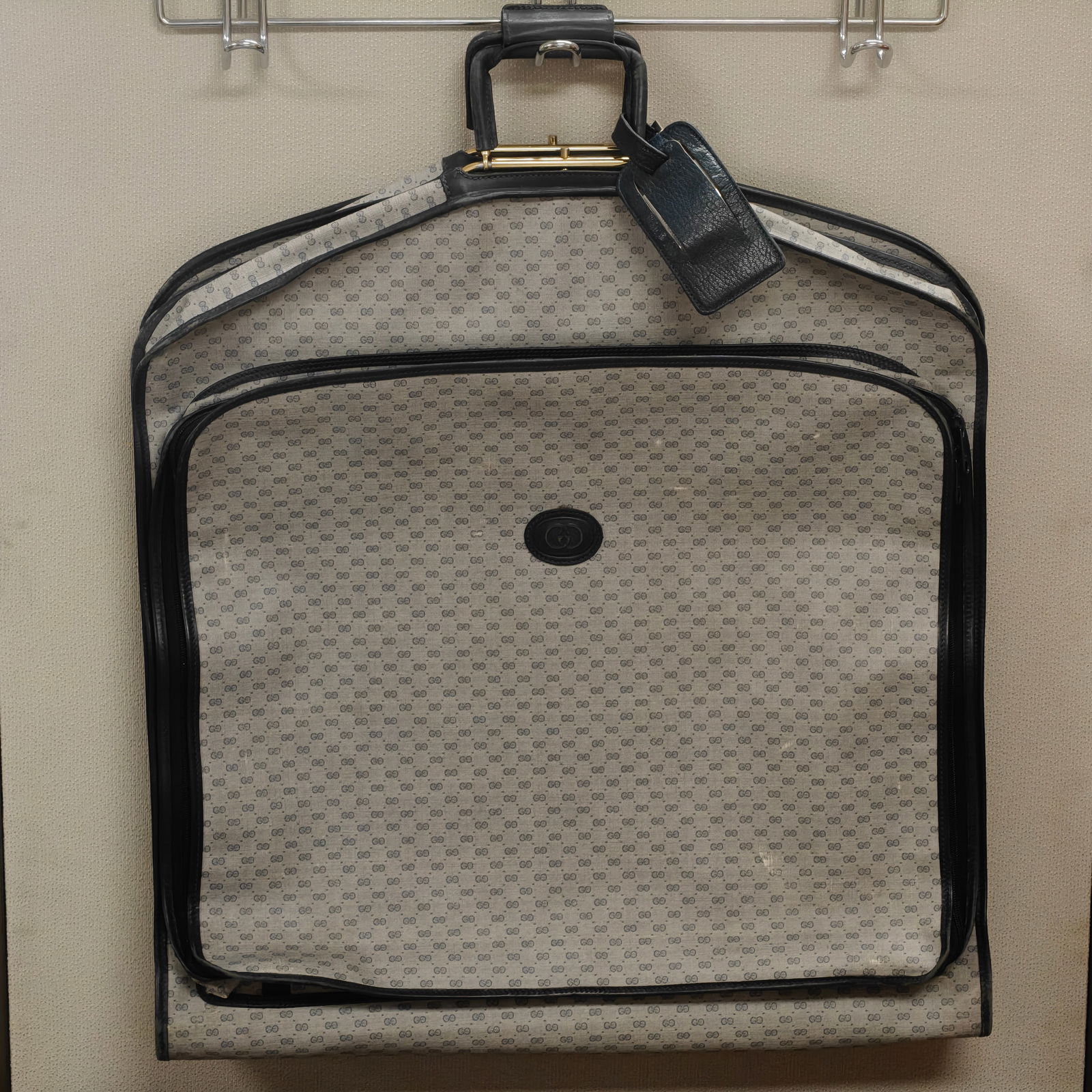 Vintage Gucci Garment Bag - Blue Monogram Canvas, 24" x 38": Elegant vintage Gucci garment bag in signature beige canvas with interlocking GG pattern and navy blue leather trim. The interior is lined in deep blue fabric, complete with original hanger and matchi