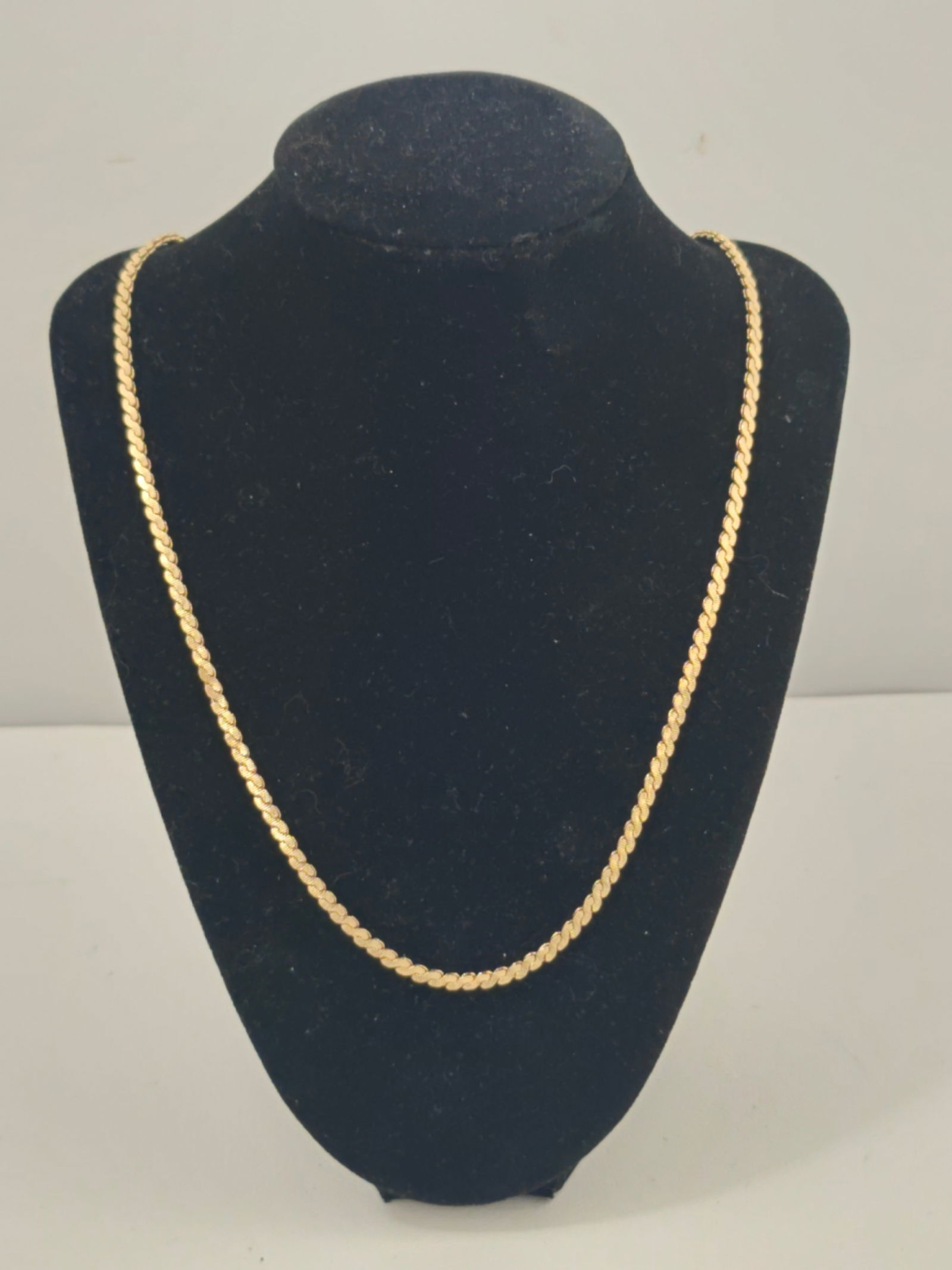 14K Gold S-Link Chain Necklace, 22 Inches: Marked 14K yellow gold chain necklace featuring an S-shaped link design. Measures approximately 22 inches in length and weighs 23.4 grams. Finished with a spring ring clasp. Light surface wear