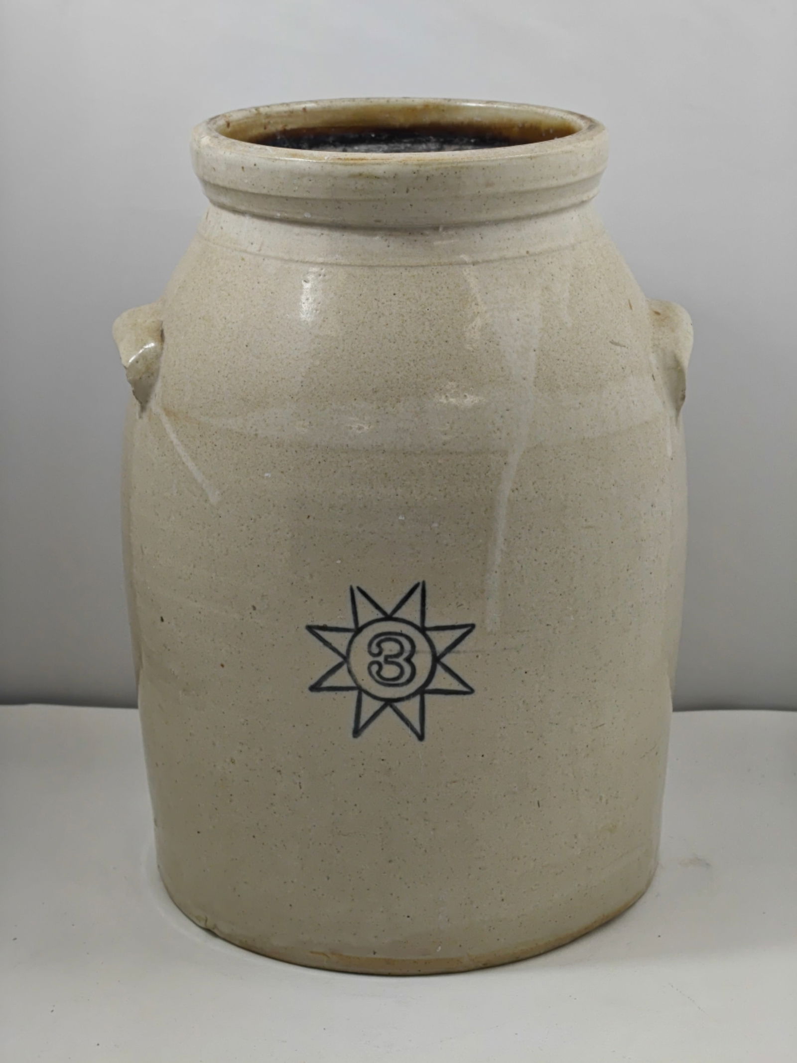 Three Gallon Stoneware Butter Churn Crock with Cobalt Star Decoration: Antique three gallon stoneware butter churn crock featuring a classic salt-glazed finish with cobalt blue starburst decoration centered with the number “3.” Traditional cylindrical form with