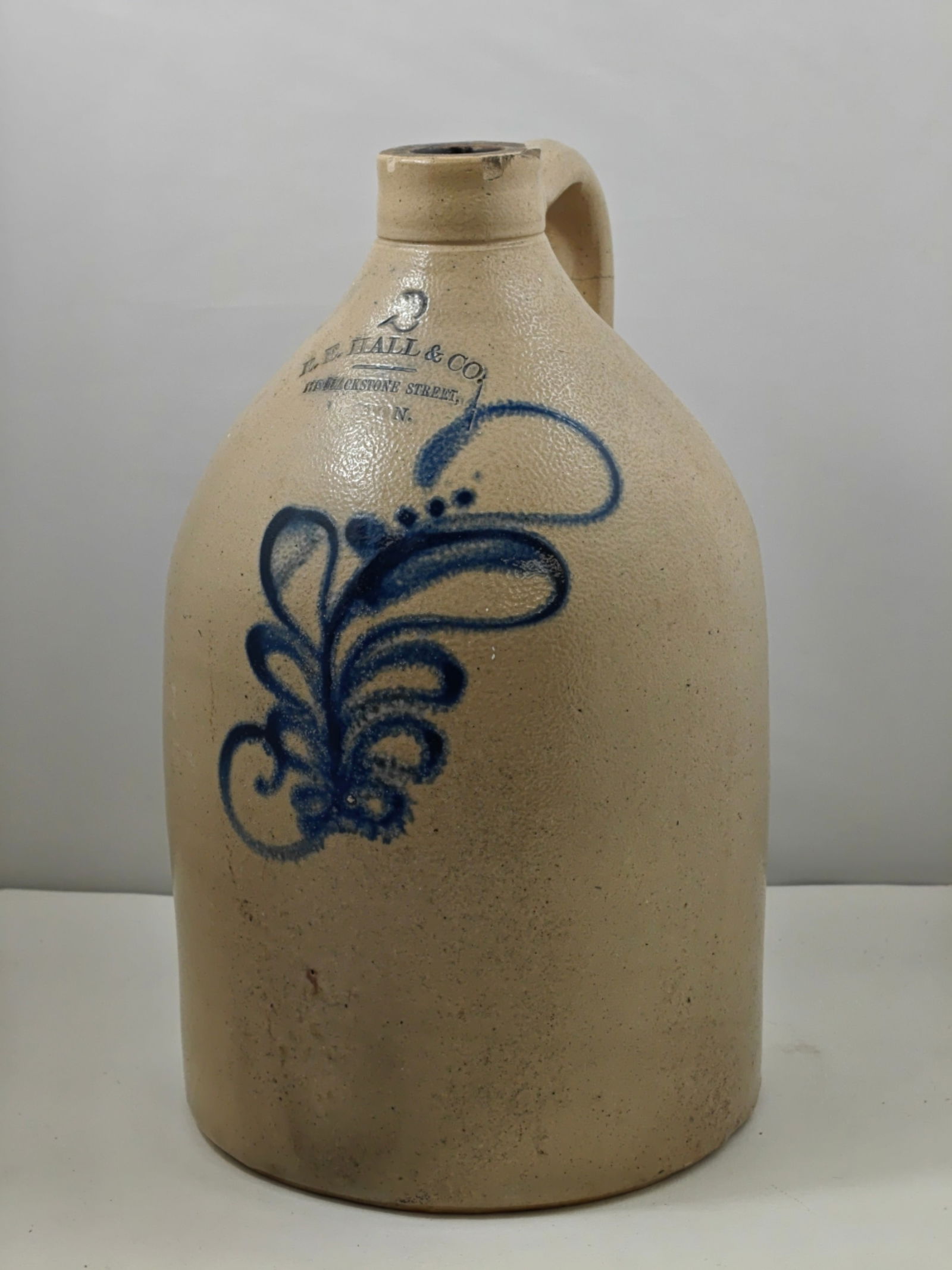 Late 19th Century L. E. Hall & Co. Blue Decorated Stoneware Jug: Attractive late 19th century salt-glazed stoneware jug by L. E. Hall & Co., Blackstone Street, Boston, featuring classic cobalt blue hand-decorated floral motif and impressed maker’s mark beneath a