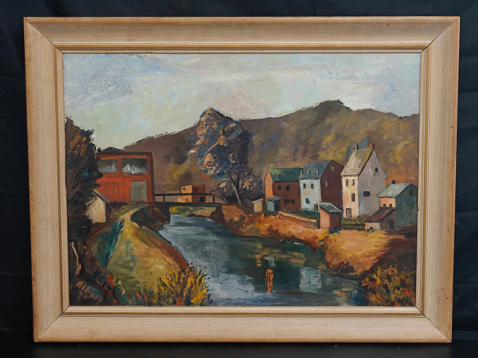 Albert Raty (Belgian, 1889–1970), Village by a River, Oil on Canvas: A Post-Impressionist river landscape by Belgian painter Albert Raty depicting a quiet village with clustered houses along a reflective waterway. The composition features bold, structured brushwork