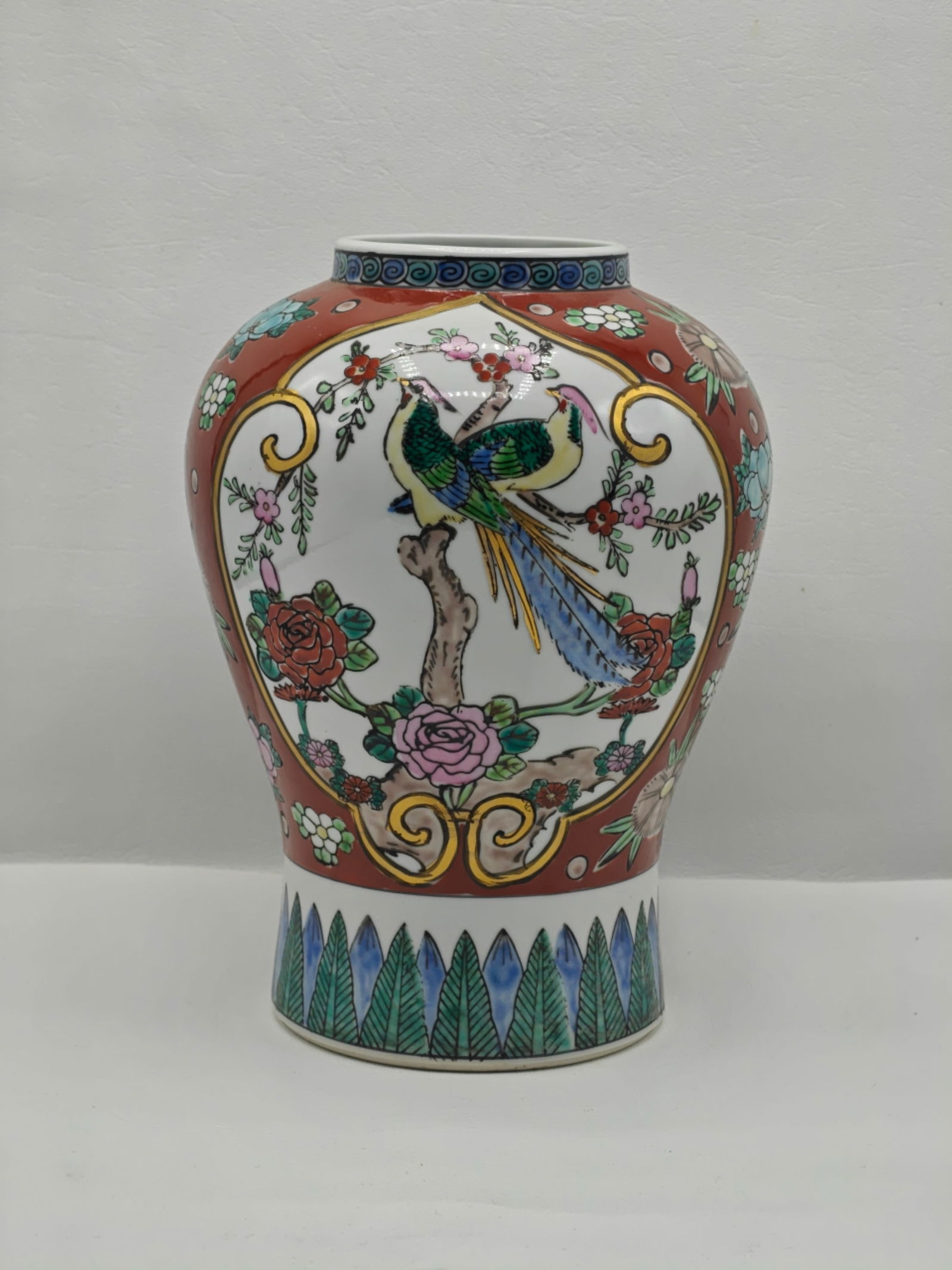 Gold Imari Hand Painted Porcelain Vase with Bird Motif 10 Inches: Hand painted porcelain vase marked Gold Imari Japan featuring a rounded form with a short neck and wide mouth. Decorated with a central panel depicting a colorful bird perched on a branch surrounded b