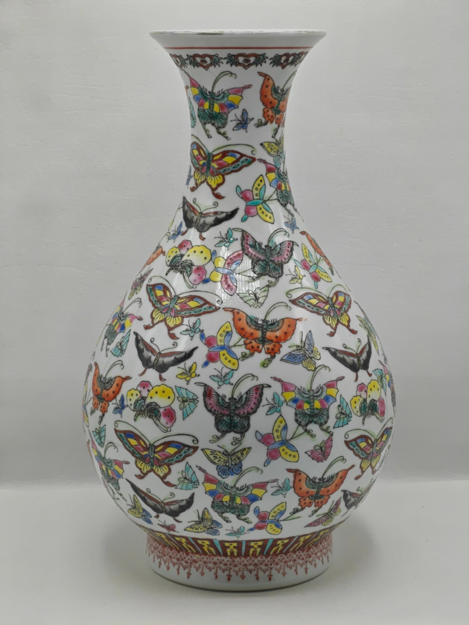 Chinese Famille Rose Porcelain “Hundred Butterflies" Vase, 15 Inches: Finely decorated Chinese porcelain vase in the classic “hundred butterflies” (bai die) pattern, featuring numerous vividly enameled butterflies in flight across a white ground. The vase has a
