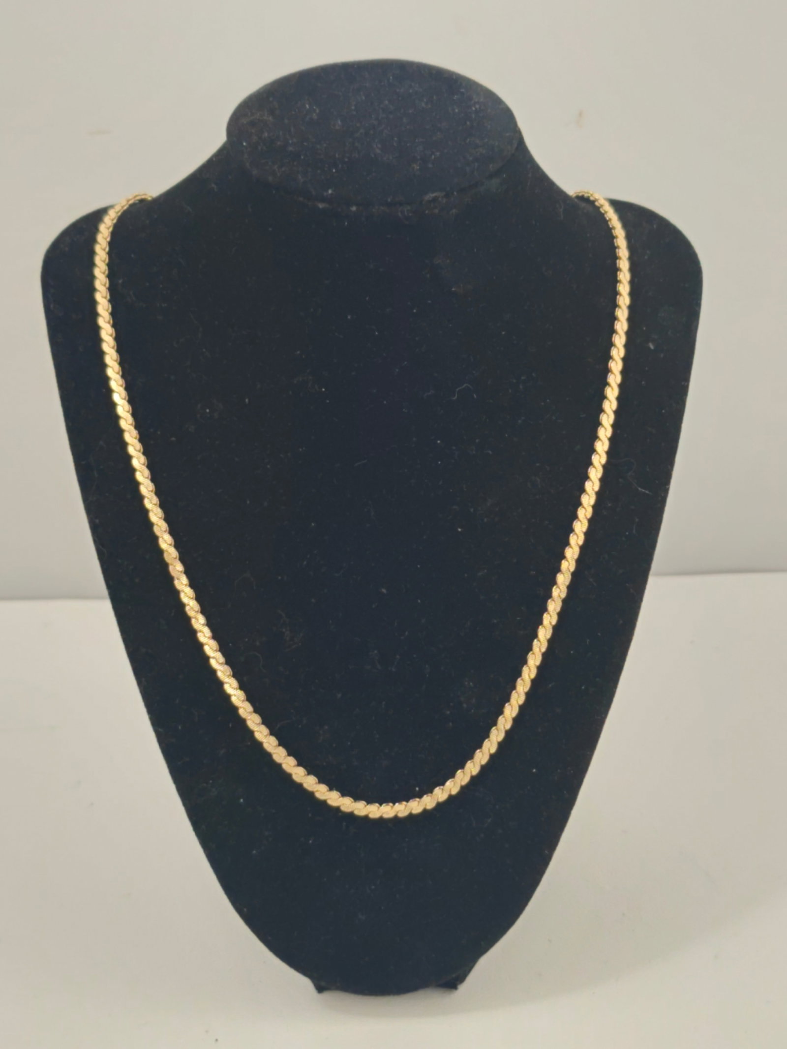 14K Gold S-Link Chain Necklace, 22 Inches: Marked 14K yellow gold chain necklace featuring an S-shaped link design. Measures approximately 22 inches in length and weighs 23.4 grams. Finished with a spring ring clasp. Light surface wear consist