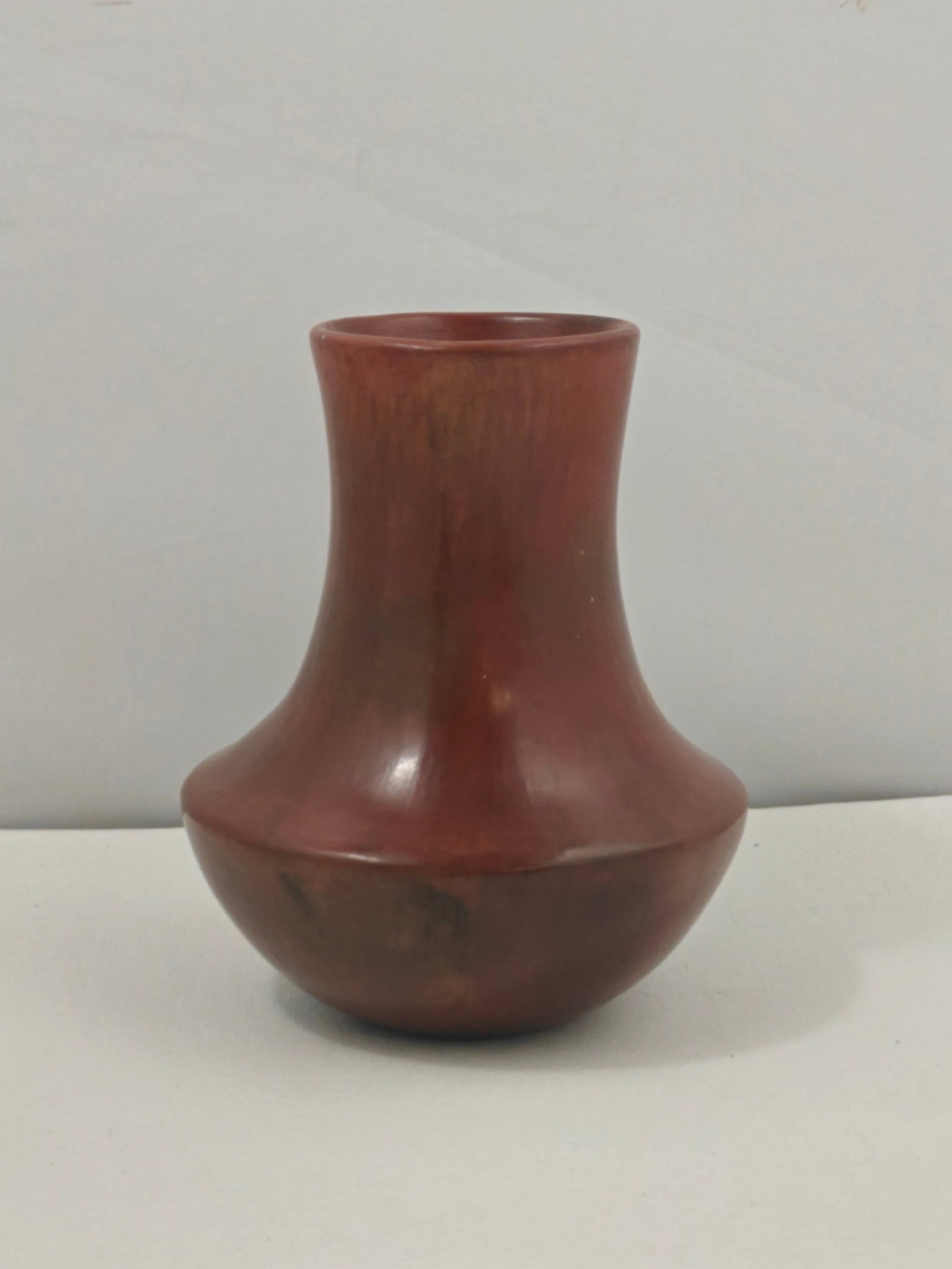 Alice Cling Navajo Pottery Vase: Hand-coiled Navajo pottery vase by noted artist Alice Cling, featuring a classic rounded body with a tapered neck and matte burnished surface. Displays rich natural earth tones with characteristic fir